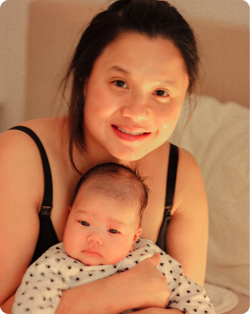 Mum holding her newborn baby in a polka dot blanket, from the Silverette personal story